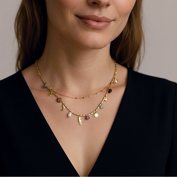 Boho celestial layered gold necklace with moon, star & seahorse charms, gemstones & pearl. 18K gold-plated. Perfect for bohemian style & everyday elegance.