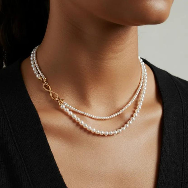 Elegant dual-strand pearl necklace with gold infinity clasp. Wear together or separately. Versatile layered design perfect for everyday elegance & special occasions.