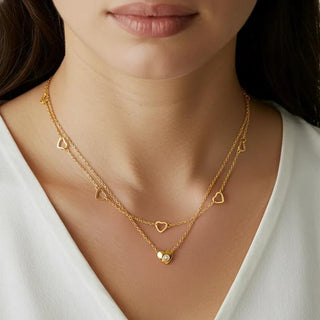 Romantic layered gold necklace with heart charms & cubic zirconia. Double-layer design, adjustable fit. Perfect for everyday elegance & date nights.