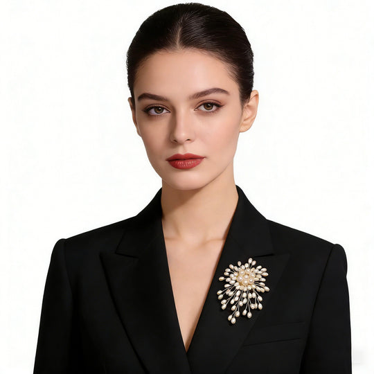 Stunning pearl burst brooch with gold-toned wires. 3-inch statement pin perfect for weddings, blazers & dresses. Elegant gift box included. Shop Jinaire's luxury brooches.