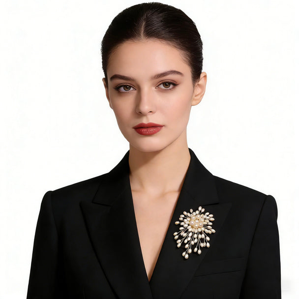 Stunning pearl burst brooch with gold-toned wires. 3-inch statement pin perfect for weddings, blazers & dresses. Elegant gift box included. Shop Jinaire's luxury brooches.