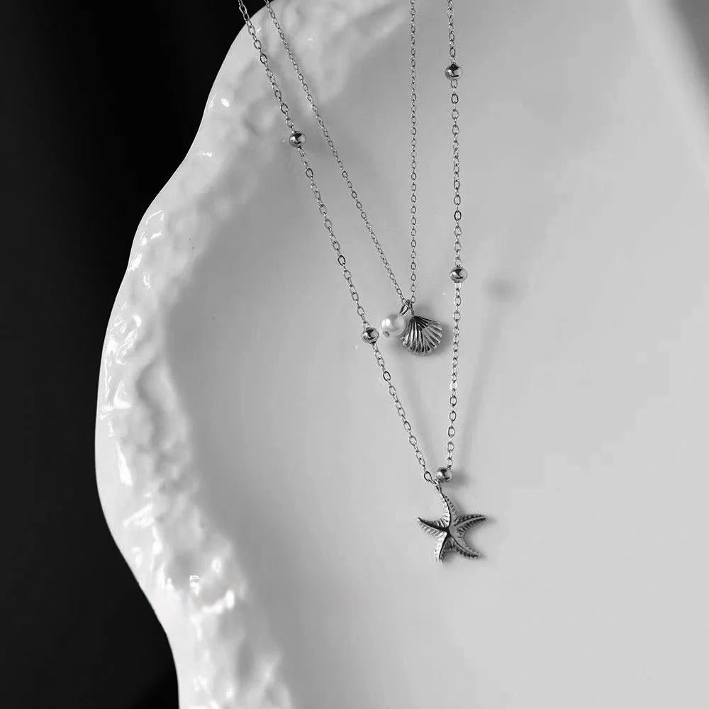 Delicate layered necklace set with seashell, pearl & starfish charms. Gold or silver coastal jewelry. Wear together or separately. Perfect for everyday style.