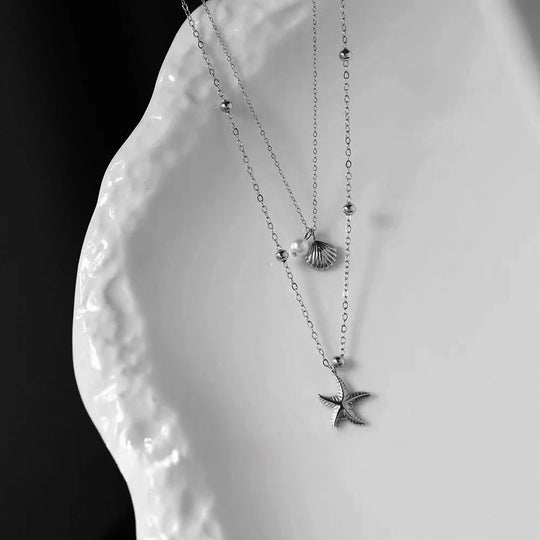 Delicate layered necklace set with seashell, pearl & starfish charms. Gold or silver coastal jewelry. Wear together or separately. Perfect for everyday style.