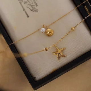 Delicate layered necklace set with seashell, pearl & starfish charms. Gold or silver coastal jewelry. Wear together or separately. Perfect for everyday style.