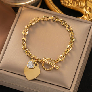 Bold gold curb chain bracelet with double heart charms & pavé CZ. Toggle clasp, adjustable fit. Perfect for everyday style & romantic gifts.