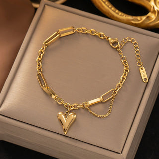Gold heart charm bracelet with mixed paperclip & curb chain. Adjustable fit, stackable design. Perfect gift for everyday style & romantic elegance.