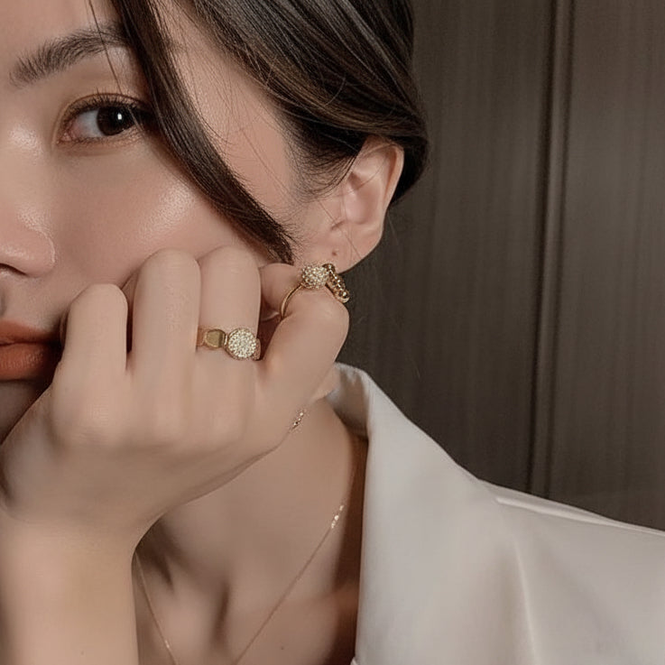 Modern gold disc ring with pavé cubic zirconia. Adjustable sculptural design, stackable. Perfect for statement style & everyday elegance.