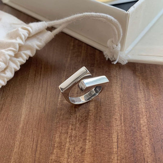 925 sterling silver open ring with geometric double-layer design. Adjustable fit, hypoallergenic. Modern minimalist statement piece perfect for everyday wear.