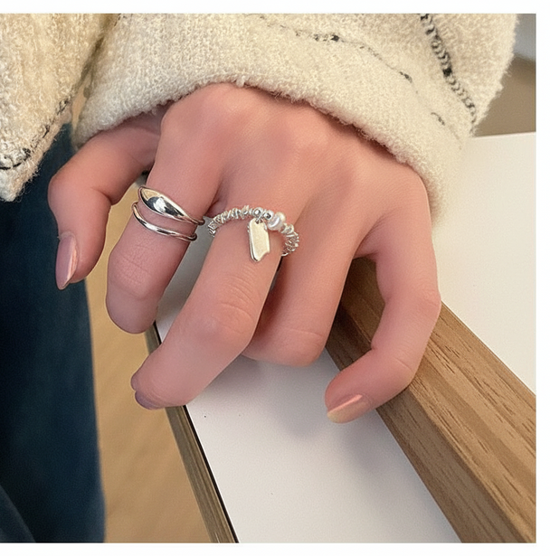 Minimalist silver ring set with open triple-band & beaded charm ring. Adjustable fit, stackable design. Perfect for everyday style & casual elegance.