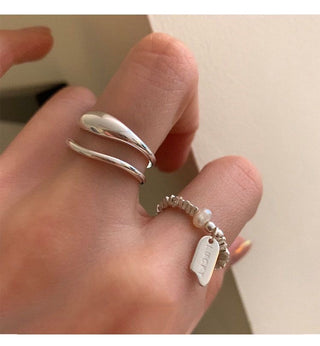 Minimalist silver ring set with open triple-band & beaded charm ring. Adjustable fit, stackable design. Perfect for everyday style & casual elegance.