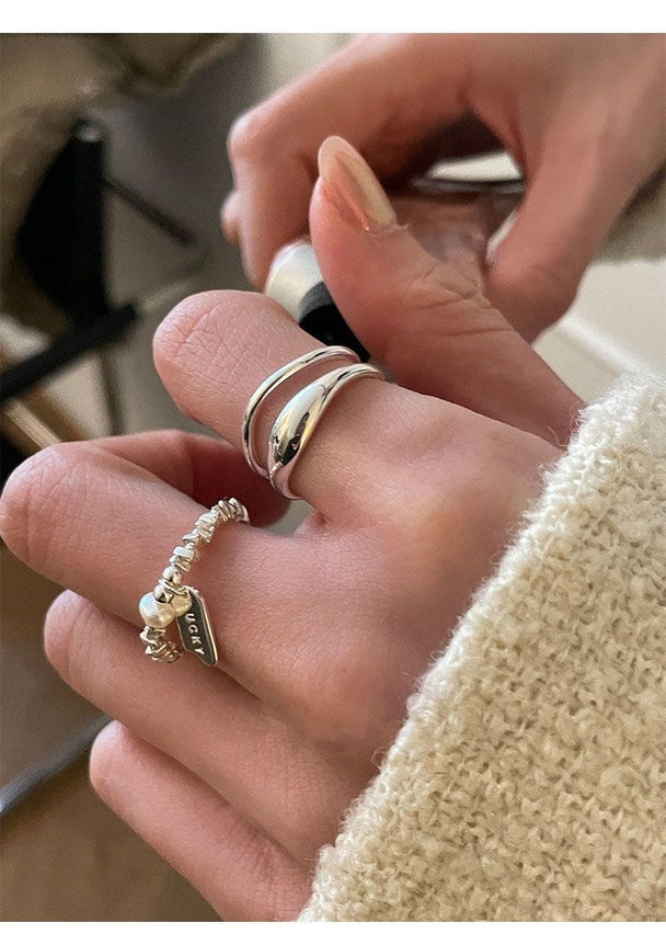 Minimalist silver ring set with open triple-band & beaded charm ring. Adjustable fit, stackable design. Perfect for everyday style & casual elegance.