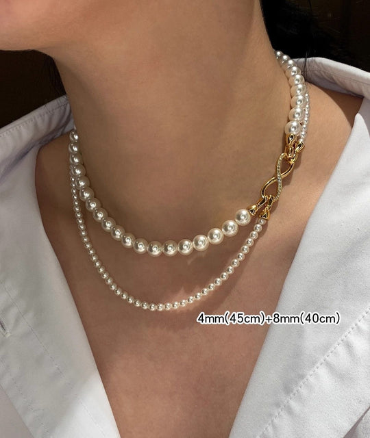 Elegant dual-strand pearl necklace with gold infinity clasp. Wear together or separately. Versatile layered design perfect for everyday elegance & special occasions.