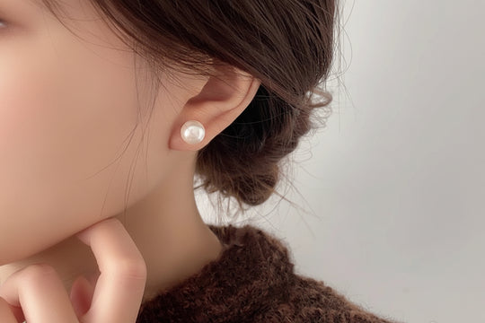 Elegant crystal pearl stud earrings in white or pink. 18K gold-plated, Swarovski pearls, 10-14mm sizes. Perfect for everyday elegance & special occasions.