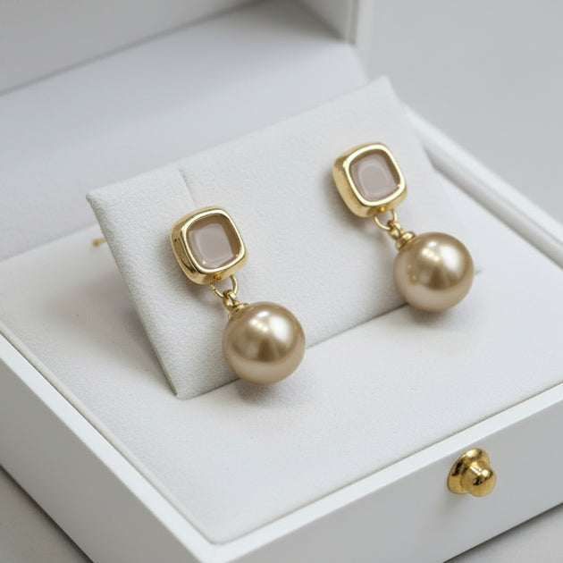 Elegant champagne gold drop earrings with faux pearl. Lightweight, versatile design. Perfect for everyday elegance & special occasions.