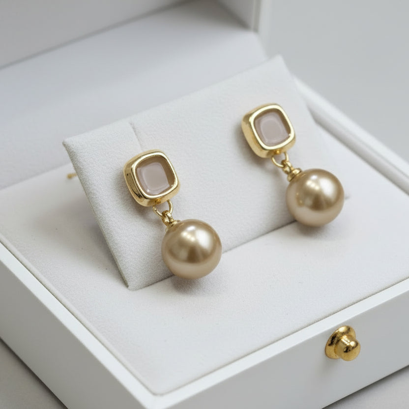 Elegant champagne gold drop earrings with faux pearl. Lightweight, versatile design. Perfect for everyday elegance & special occasions.