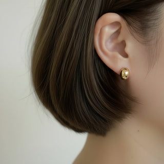 Sleek polished gold oval stud earrings with high-shine finish. Lightweight, minimalist design. Perfect for everyday elegance & effortless style.