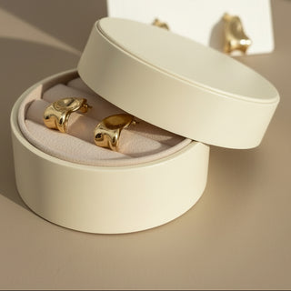 Artful gold sculpted stud earrings with organic pebble shape. Lightweight, polished finish. Perfect for everyday elegance & creative style.