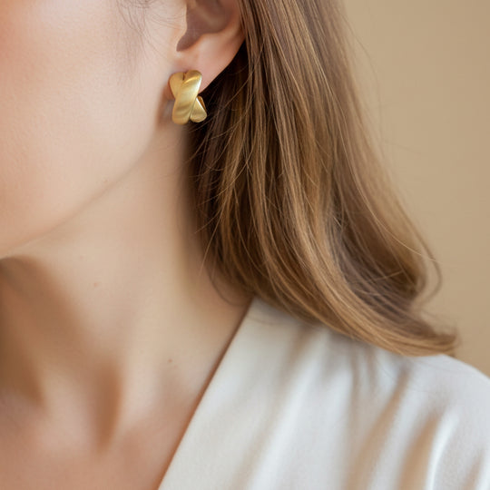 Elegant gold knot stud earrings with twisted design. Lightweight, matte finish. Perfect for everyday elegance & office wear.