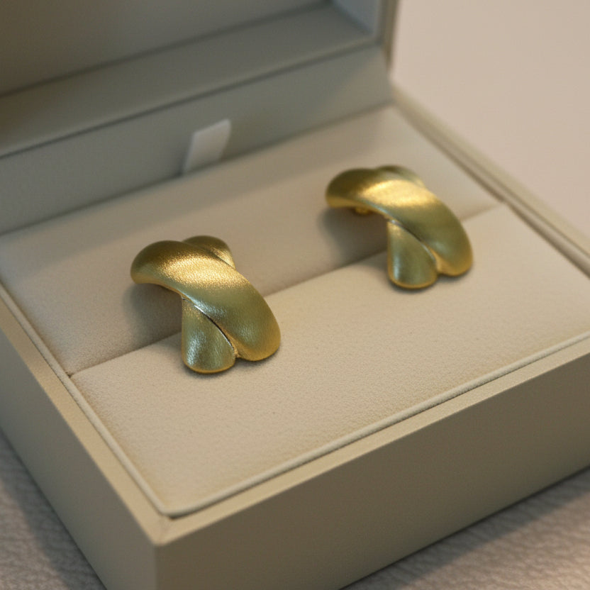 Elegant gold knot stud earrings with twisted design. Lightweight, matte finish. Perfect for everyday elegance & office wear.