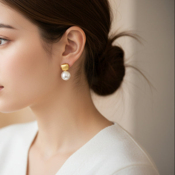 Modern gold drop earrings with textured square studs & white pearls. Lightweight, elegant design. Perfect for office wear & everyday sophistication.