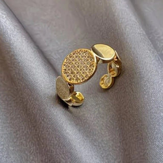 Modern gold disc ring with pavé cubic zirconia. Adjustable sculptural design, stackable. Perfect for statement style & everyday elegance.