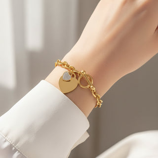 Bold gold curb chain bracelet with double heart charms & pavé CZ. Toggle clasp, adjustable fit. Perfect for everyday style & romantic gifts.