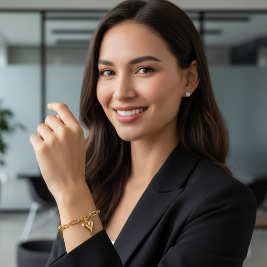 Gold heart charm bracelet with mixed paperclip & curb chain. Adjustable fit, stackable design. Perfect gift for everyday style & romantic elegance.