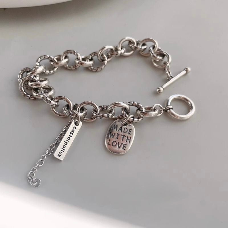 Edgy double-layered silver chain bracelet with toggle clasp & Made With Love charm. Adjustable fit, stackable. Perfect for everyday style & layering.