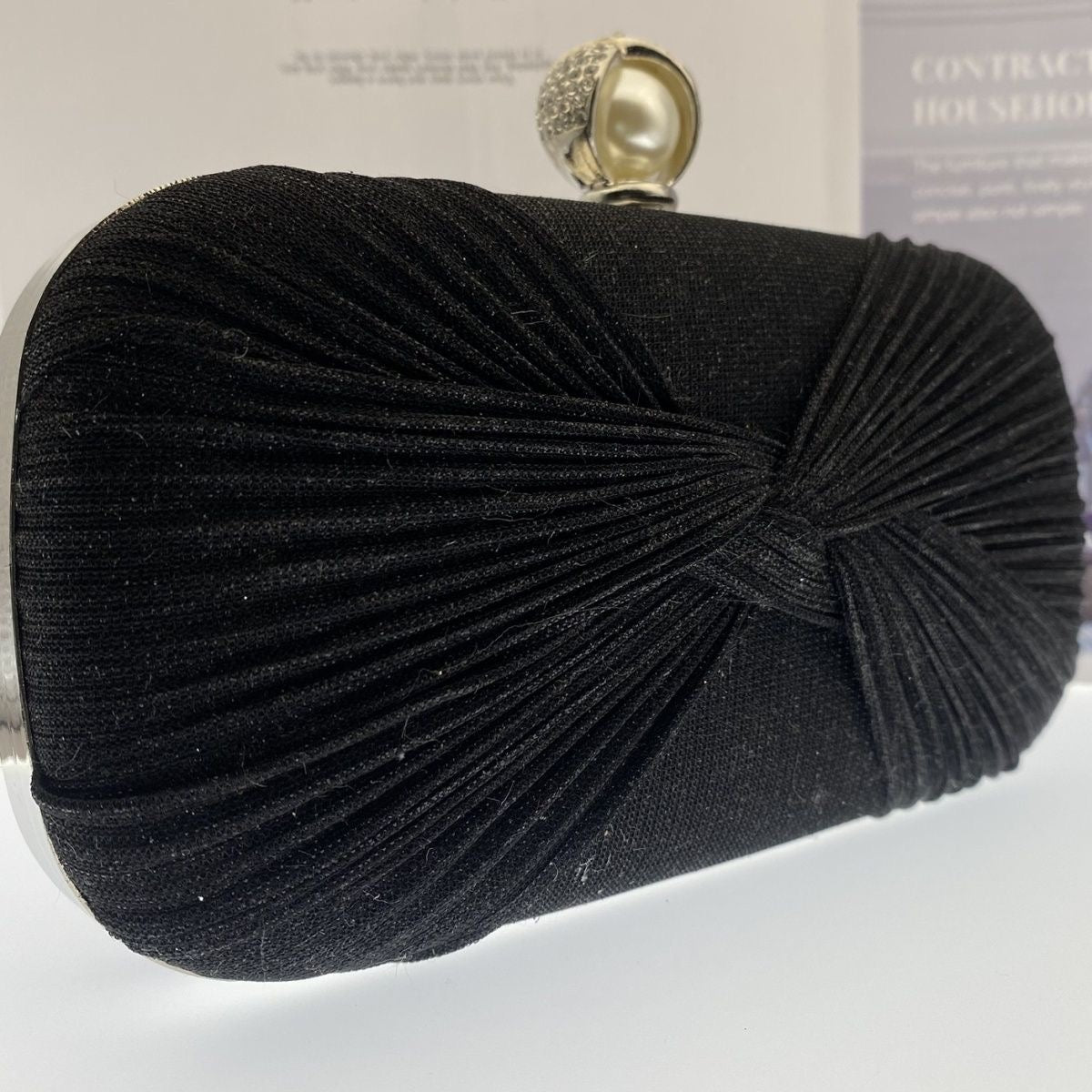 Elegant pleated evening clutch with pearl clasp. Black, silver & gold options. Dual chains for versatile wear. Perfect for weddings, galas, cocktail parties & formal events.