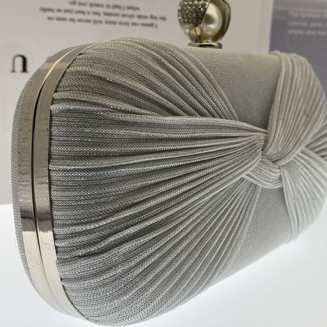Elegant pleated evening clutch with pearl clasp. Black, silver & gold options. Dual chains for versatile wear. Perfect for weddings, galas, cocktail parties & formal events.