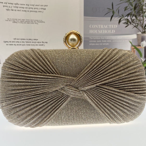 Elegant pleated evening clutch with pearl clasp. Black, silver & gold options. Dual chains for versatile wear. Perfect for weddings, galas, cocktail parties & formal events.