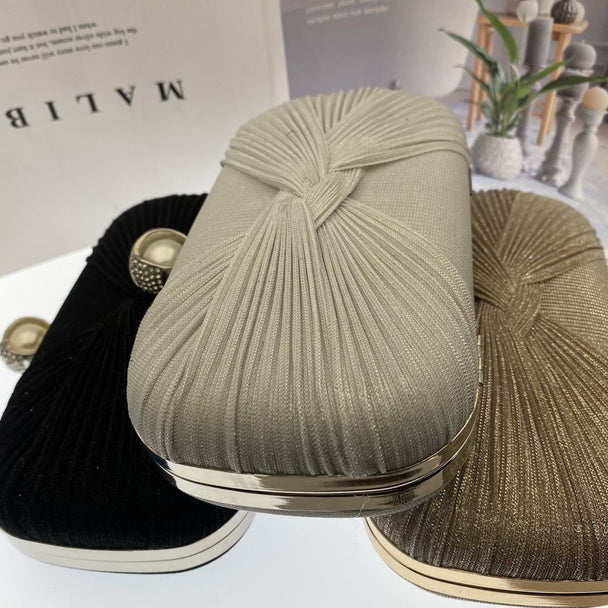 Elegant pleated evening clutch with pearl clasp. Black, silver & gold options. Dual chains for versatile wear. Perfect for weddings, galas, cocktail parties & formal events.