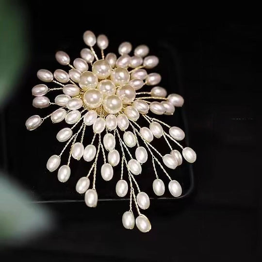 Stunning pearl burst brooch with gold-toned wires. 3-inch statement pin perfect for weddings, blazers & dresses. Elegant gift box included. Shop Jinaire's luxury brooches.