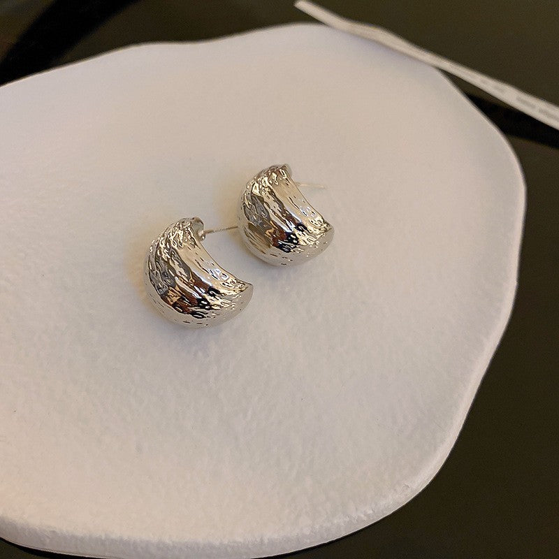 Modern textured wave hoop earrings in gold or silver. Lightweight sculptural design. Perfect for everyday elegance & office style.