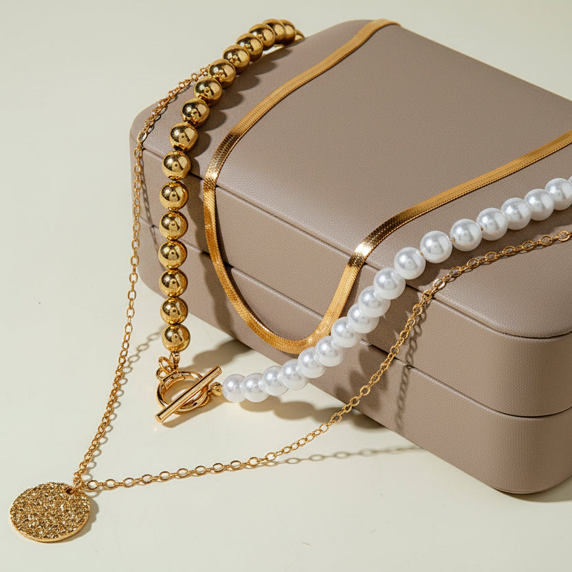 Elegant layered Y-necklace with faux pearls & gold pendants. Multi-strand bohemian design. Perfect for everyday elegance & special occasions.