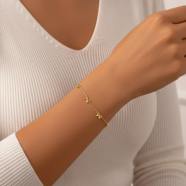 Delicate gold bow bracelet with stainless steel chain. Adjustable, lightweight design. Perfect for everyday elegance & romantic style.