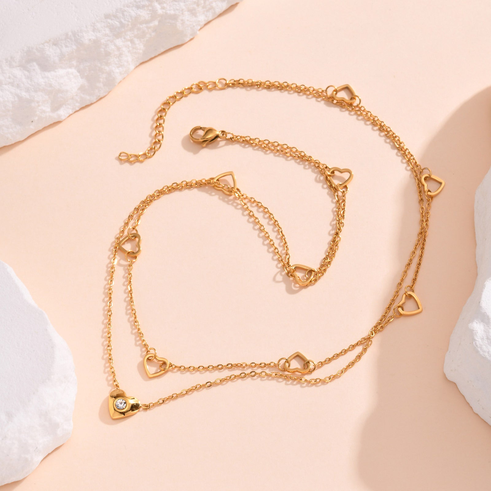 Romantic layered gold necklace with heart charms & cubic zirconia. Double-layer design, adjustable fit. Perfect for everyday elegance & date nights.