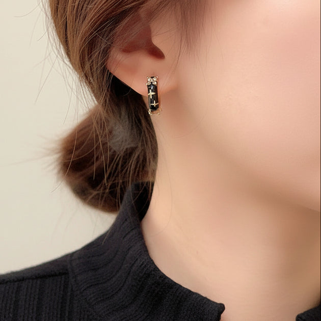 Edgy black enamel hoop earrings with gold cross & cubic zirconia. Lightweight medium hoops. Perfect for gothic style & bold everyday looks.