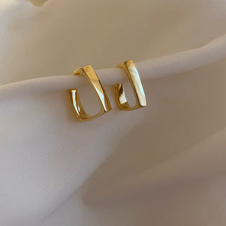 Modern gold bar stud earrings with faceted detail. Lightweight, stackable design. Perfect for everyday elegance & office sophistication.