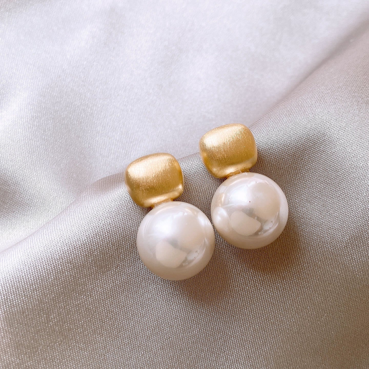 Modern gold drop earrings with textured square studs & white pearls. Lightweight, elegant design. Perfect for office wear & everyday sophistication.