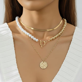 Elegant layered Y-necklace with faux pearls & gold pendants. Multi-strand bohemian design. Perfect for everyday elegance & special occasions.