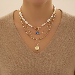 Bold layered pearl necklace with rhinestone pendants. Multi-strand collar design. Perfect for special occasions & statement style.