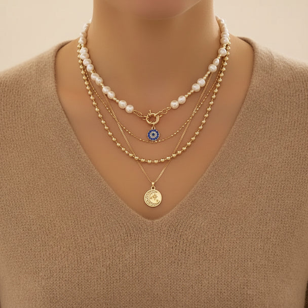 Bold layered pearl necklace with rhinestone pendants. Multi-strand collar design. Perfect for special occasions & statement style.