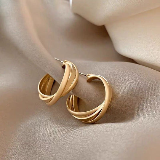 Modern twisted gold hoop earrings with layered design. Lightweight matte finish. Perfect for everyday elegance & office style.