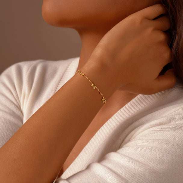 Delicate gold bow bracelet with stainless steel chain. Adjustable, lightweight design. Perfect for everyday elegance & romantic style.
