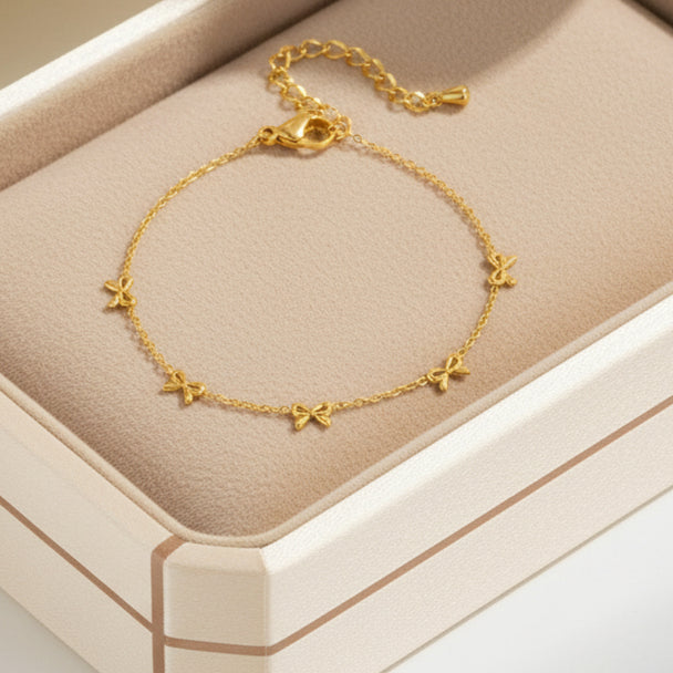 Delicate gold bow bracelet with stainless steel chain. Adjustable, lightweight design. Perfect for everyday elegance & romantic style.