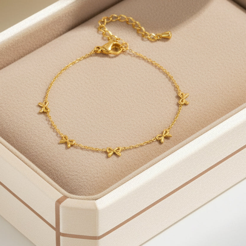 Delicate gold bow bracelet with stainless steel chain. Adjustable, lightweight design. Perfect for everyday elegance & romantic style.