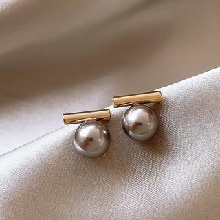Modern gold bar stud earrings with gray pearls. Lightweight minimalist design. Perfect for office sophistication & everyday elegance.
