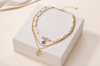 Bold layered pearl necklace with rhinestone pendants. Multi-strand collar design. Perfect for special occasions & statement style.