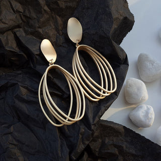 Boho gold teardrop earrings with layered multi-ring design. Lightweight, sculptural style. Perfect for everyday elegance & festival vibes.